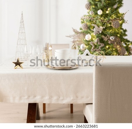 Festive Dining Table Setting, White Dinnerware Set, Crystal, Christmas Theme with Illuminated Tree Adorned with Metallic Decorations and Glistening Star, Golden Accents, Decorative Tablecloth.