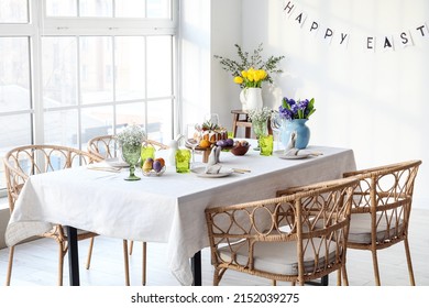 Festive Dinnerware And Beautiful Flowers On Table Served For Easter Celebration In Light Room Interior