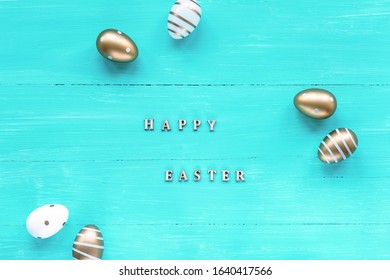 Festive Easter background. Painted golden eggs on turquoise wooden table. Easter celebration concept template. Top view, flat lay. - Powered by Shutterstock