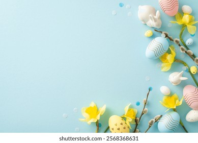 Festive Easter composition featuring pastel eggs, yellow daffodils, and ceramic bunnies on a soft blue background, perfect for seasonal and holiday-themed projects