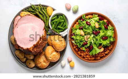 A festive Easter meal featuring a succulent ham, roasted potatoes, fresh asparagus, and a vibrant bean salad, perfect for holiday celebrations.