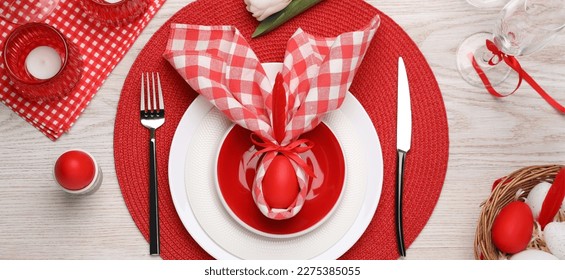 Festive Easter table setting with bunny ears made of egg and napkin on white wooden background, flat lay. Banner design - Shutterstock ID 2275385055