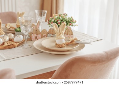 Festive Easter table setting with Easter bunny made from egg and knitted ears. Easter celebration concept - Powered by Shutterstock - Get 15% off with code: PIKWIZARD15