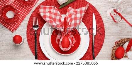Festive Easter table setting with bunny ears made of egg and napkin on white wooden background, flat lay. Banner design