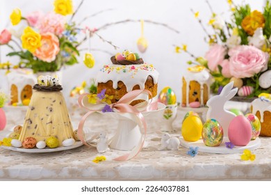 Festive Easter table setting. Easter cake, Easter Eggs, Flower arrangements and home decorations for holiday. - Powered by Shutterstock