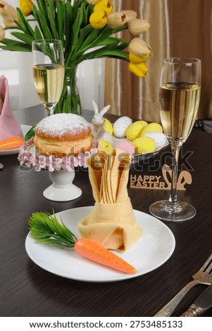 Festive Easter table setting with a decoratively folded napkin in the shape of a bunny and carrot