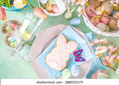 Festive Easter Table Setting With Traditional Spring Flowers, Colorful Eggs And Sugar Cookies. Greeting Card Background Copy Space