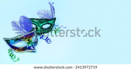 Festive face mask for carnival celebration on colored background with copy space.