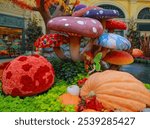 Festive fairy Thanksgiving decoration with huge mushrooms and pumpkin.