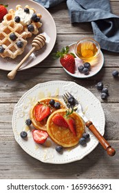 Festive Family Dessert Table With  Pancakes, Waffles, Sweets And Fresh Strawberry. Overhead View