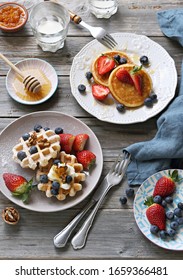 Festive Family Dessert Table With  Pancakes, Waffles, Sweets And Fresh Strawberry. Overhead View