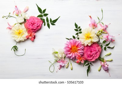 Festive flower composition on the white wooden background. Overhead view.