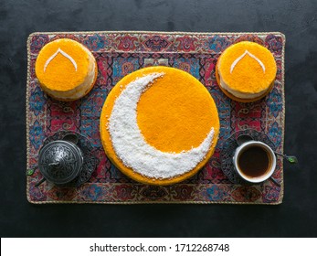 Festive Food Ramadan Background. Delicious Homemade Golden Cake With A Crescent Moon, Served With Black Coffee And Dates. Top View.