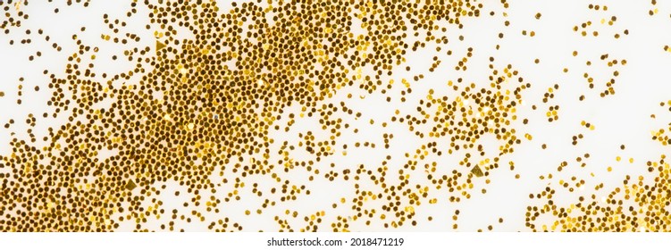 Festive Or Glamorous Background. Gold Sparkles Scattered On A White Background.