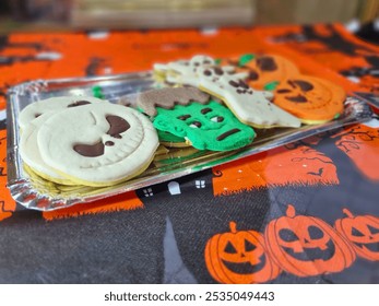 Festive Halloween cookies shaped like pumpkins, ghosts, and monsters. Colorful icing decorations create a playful and spooky theme, perfect for the holiday season. Candy decoration window display. - Powered by Shutterstock