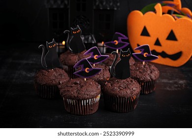 Festive Halloween cupcakes and treats decorated with funny stickers. Halloween muffins. Chocolate muffins - Powered by Shutterstock