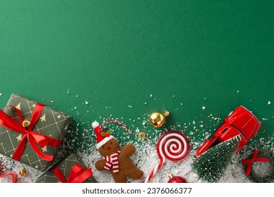 Festive Holiday Arrangement: Top view gift boxes, baubles, gingerbread man ornament, jingling bells, miniature car carrying tiny fir tree, etc on snowy green backdrop. Perfect for greeting text or ads - Powered by Shutterstock