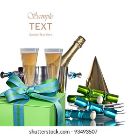 Festive Holiday Champagne In Silver Bucket Wine Cooler For Romantic New Years Celebration With Vintage White Plates, Gold Party Hat, Green & Blue Gift And Party Favors