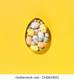 Festive holiday Easter composition. Yellow, pink, blue and white easter eggs on paper yellow background. Spring Easter card concept. Flat lay, top view, copy space. - Shutterstock ID 2140653021