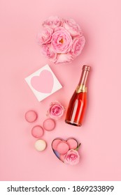 Festive Holiday Greeting Card For Valentines, Birthday, Woman Or Mothers Day. Flowers, Bottle Of Wine, Sweets And Gift On Pink Background. Valentines Day Concept. Flat Lay, Top View, Copy Space.