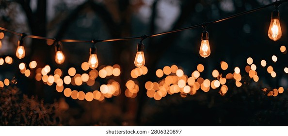 A festive and inviting scene featuring numerous illuminated string lights creating a bokeh effect against a dark background.