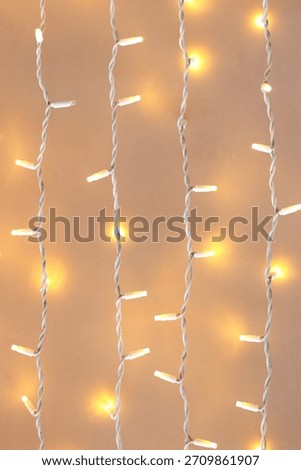 Festive LED string lights hanging on a light background