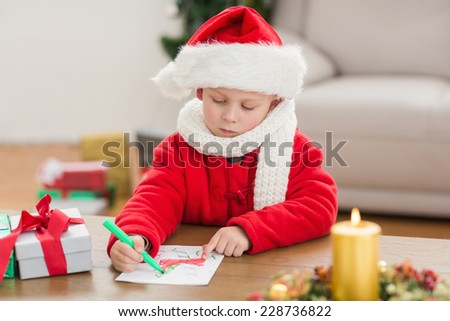 Festive little boy drawing pictures at home in the living room