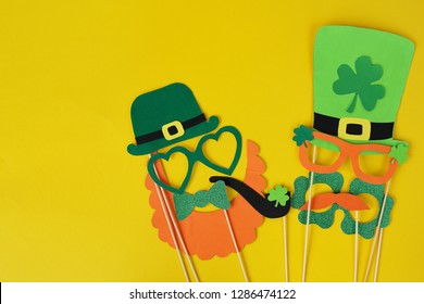 Festive Masks For A St. Patrick's Day On A Yellow Background. Fancy Dress. Party Concept. Flat Lay Objects With Paper Craft On White Wallpaper At Home Office Desk With Copy Space.