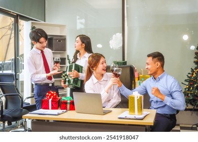 Festive office Christmas party with friends and colleagues celebrating after work. Asian business people wear Santa hats, enjoy grilled chicken, drinks, and gifts,  indoor scene with holiday lights. - Powered by Shutterstock