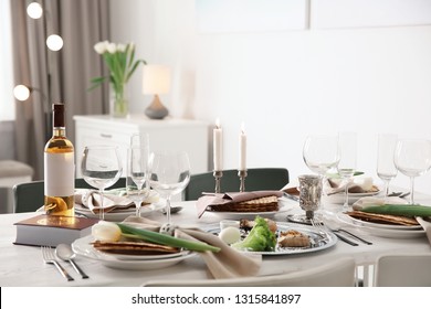 Festive Passover table setting with Torah at home. Pesach celebration
