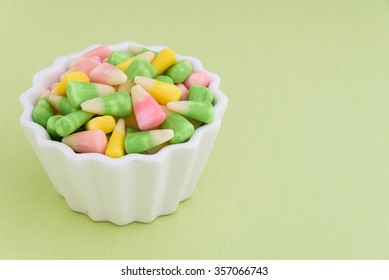 Festive Pastel Candy Corn In A White Bowl On A Light Green Background
