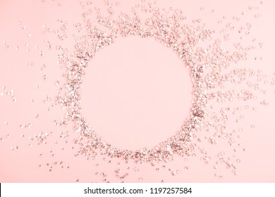 Festive pink background. Shining sequins on light pink pastel background. Christmas. Wedding. Birthday. Happy woman's day. Mothers Day. Valentine's Day. Flat lay, top view, copy space.