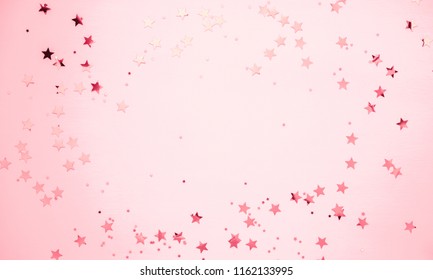 Festive pink background. Shining stars on light pink pastel background. Christmas. Wedding. Birthday. Happy woman's day. Mothers Day. Valentine's Day. Flat lay, top view, copy space.