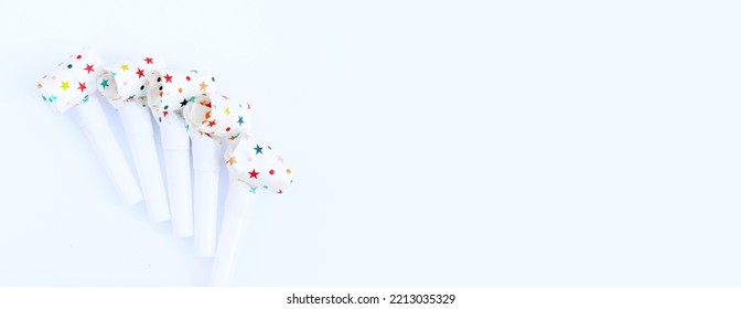 Festive Pipes And Horns On A White Background. Congratulatory Background For Your Text. Background For A Postcard Or Banner For A Birthday, New Year Or Other Holiday. Noise Makers