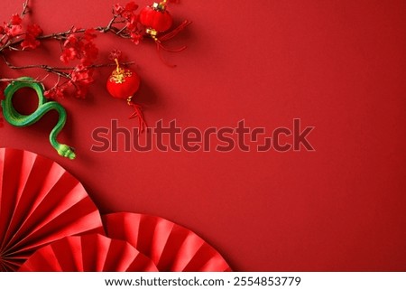 Festive red background with cherry blossoms, Chinese lanterns, green snake, and red paper fans. Perfect for Chinese New Year, cultural celebrations, and festive decorations