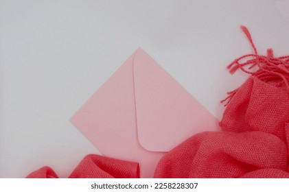 Festive, romantic concept. Pink mail envelope and pink scarf, stole on a pastel, white background. Copy space, space for text, postcard, background, - Shutterstock ID 2258228307