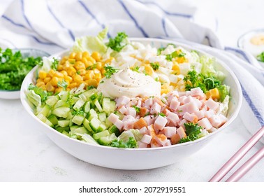 Festive Salad With Ham, Cucumber, Boiled Eggs, Sweet Corn And Mayonnaise On Rustic.