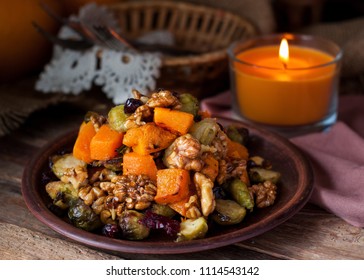 Festive salad with roasted brussels sprouts, butternut squash, pecans and cranberries glazed with honey and cinnamon sauce. 