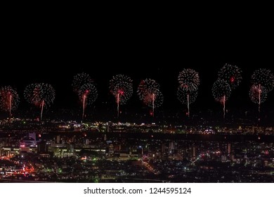 Festive salute in the night sky. Salute over the city the megalopolis. Explosions of fireworks.