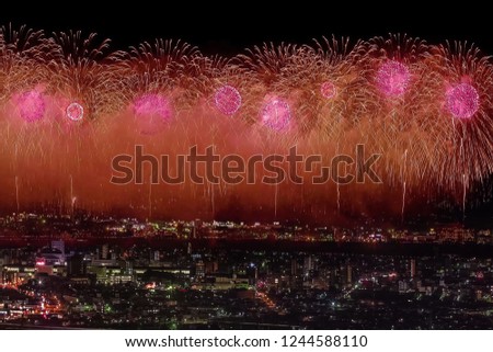 Festive salute in the night sky. Salute over the city the megalopolis. Explosions of fireworks.