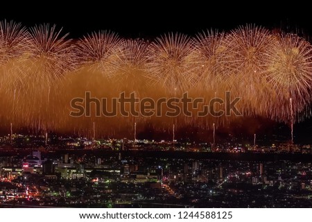 Festive salute in the night sky. Salute over the city the megalopolis. Explosions of fireworks.