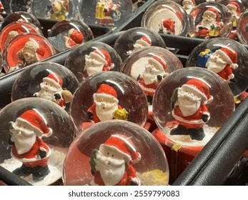 Festive santa claus snow globes display for christmas celebration. - Powered by Shutterstock