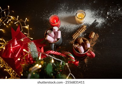 Festive scene with hot chocolate, marshmallows, candles, and Christmas decorations on a table. - Powered by Shutterstock