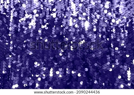 Festive sequin background in trendy purple 2022. Shining fabric background.