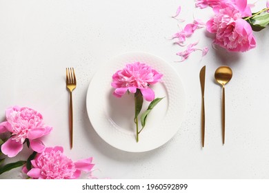 Festive Spring Table Setting With Pink Peony Flowers On A White Table. View From Above. Banquet Invitation.