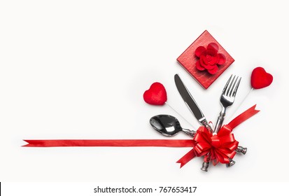 Festive Table Place Setting With Cutlery And Red Bow And Ribbon, Gift Box And Hearts On White Background, Banner. Layout For Valentines Day Dinner Invitation Or Anniversary, Banquet, Celebration