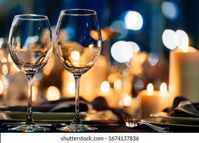 festive table setting with candles for wedding party in the dark