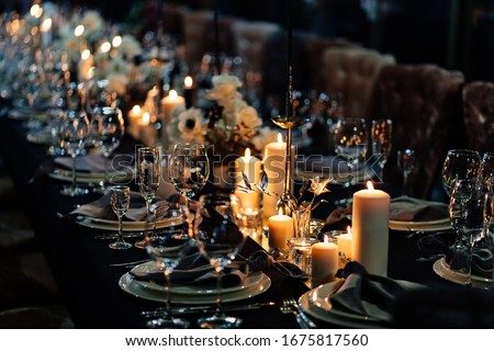 festive table setting with candles for wedding party in the dark