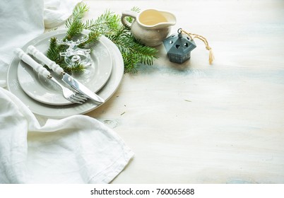 Festive table setting for Christmas dinner on rustic wooden table with copyspace