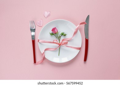 Festive Table Setting With Cutlery, Little Rose And Hearts On Pink  Table. Top View.